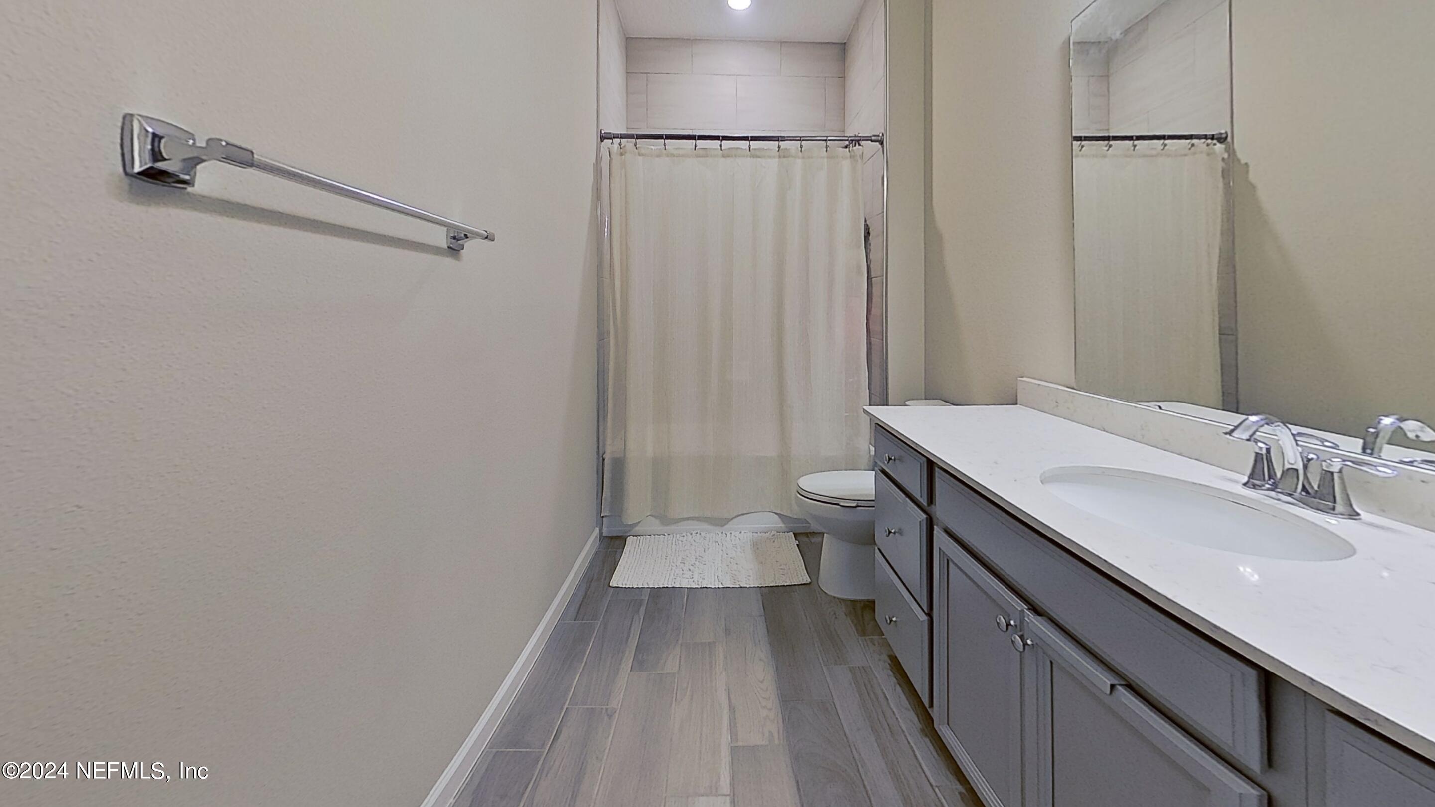 10887 Ventnor Avenue Jacksonville, FL 32218 - Photo 14 of 19 a bathroom with a sink a toilet and shower