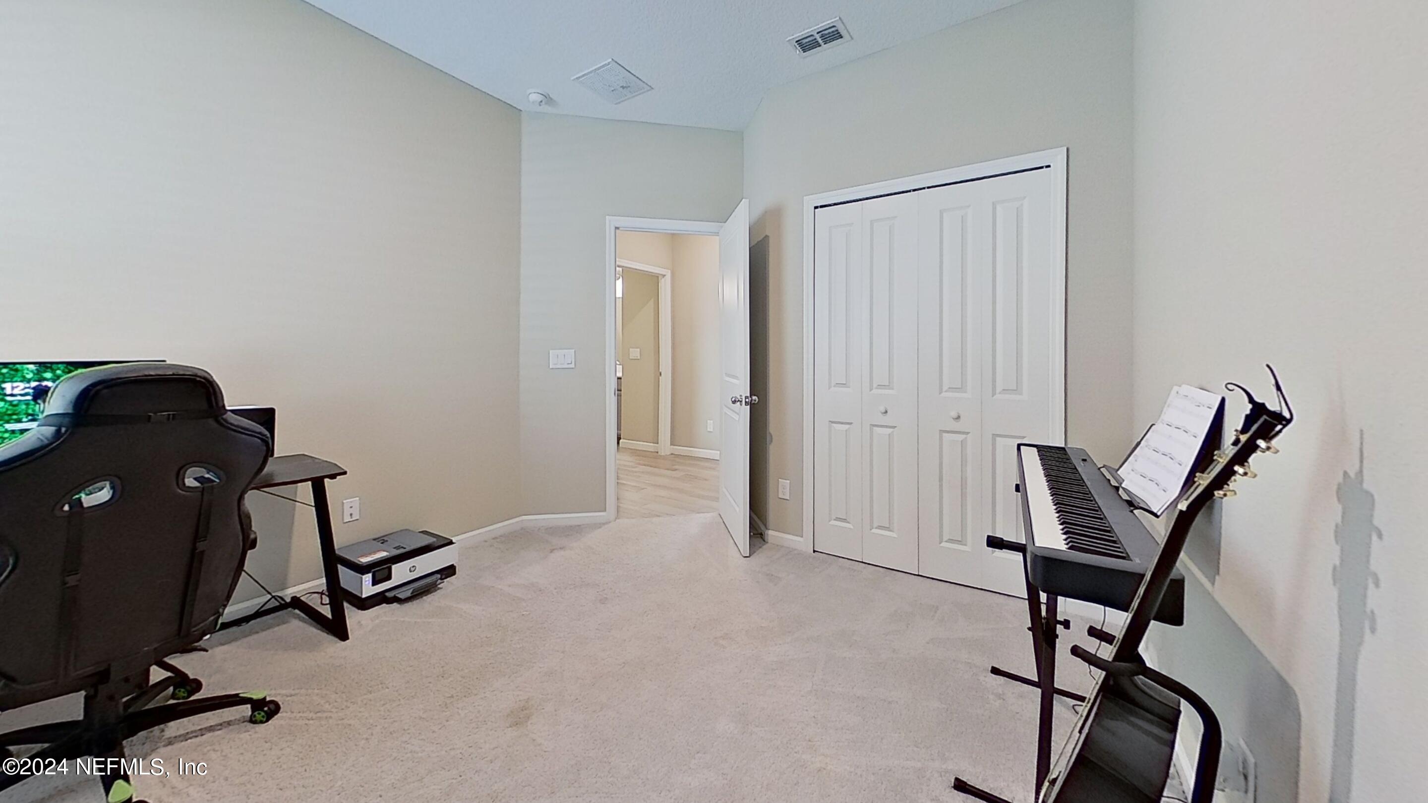 10887 Ventnor Avenue Jacksonville, FL 32218 - Photo 15 of 19 a view of a workspace with furniture and gym cycle