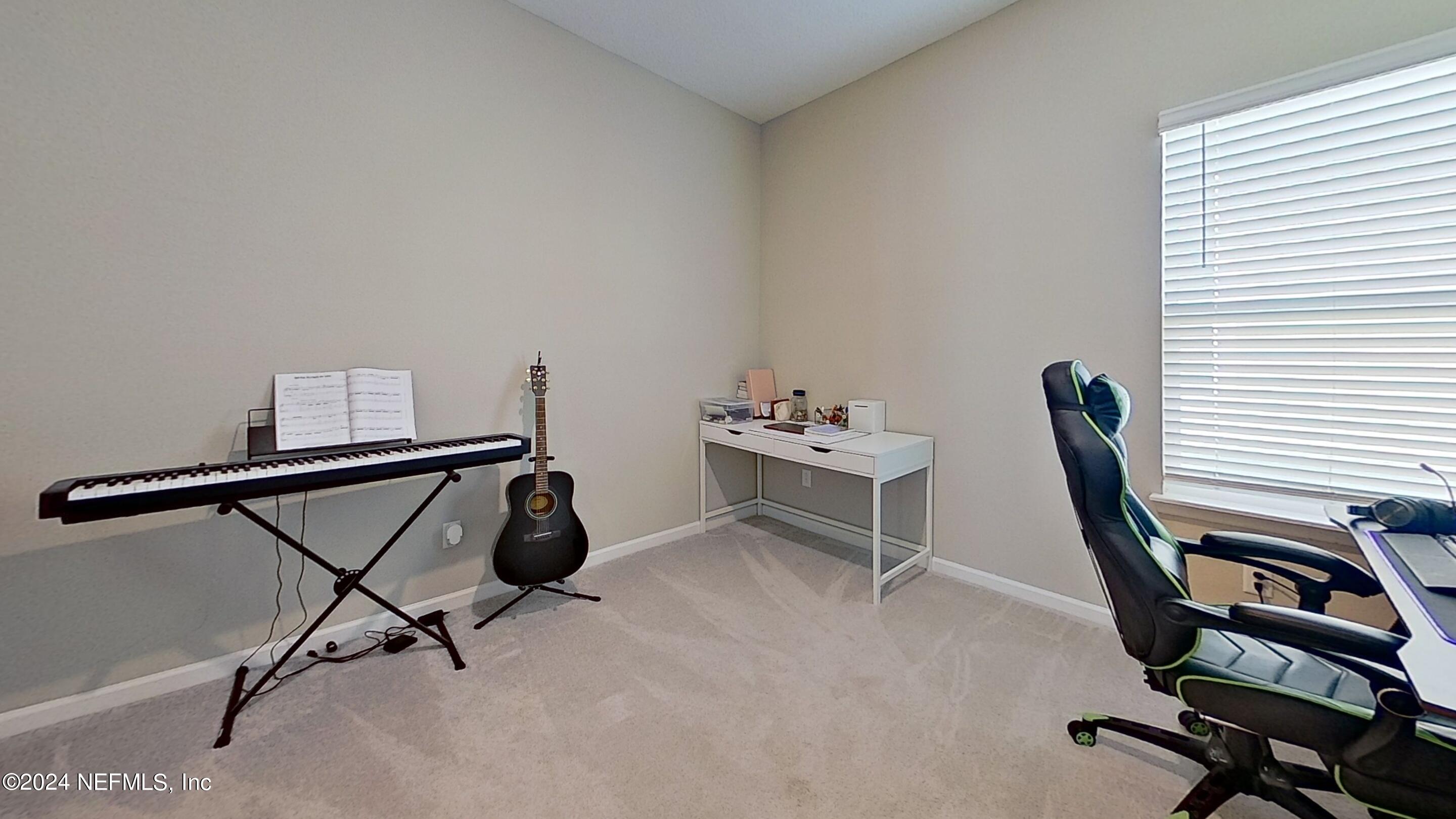 10887 Ventnor Avenue Jacksonville, FL 32218 - Photo 16 of 19 a view of a workspace with furniture and a window