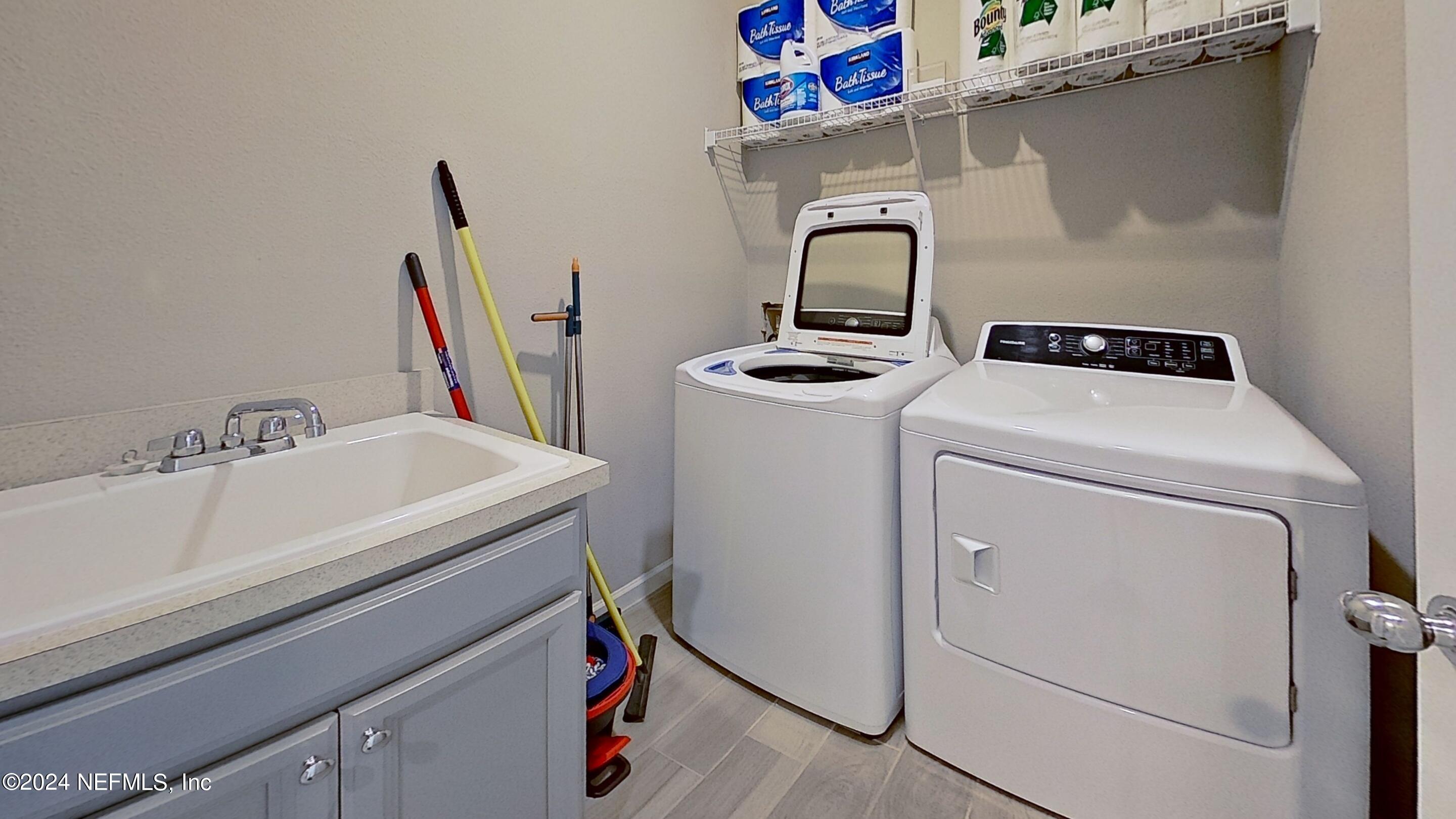 10887 Ventnor Avenue Jacksonville, FL 32218 - Photo 17 of 19 a bathroom with a sink and a washer dryer