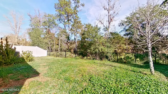 a big yard with lots of green space and trees