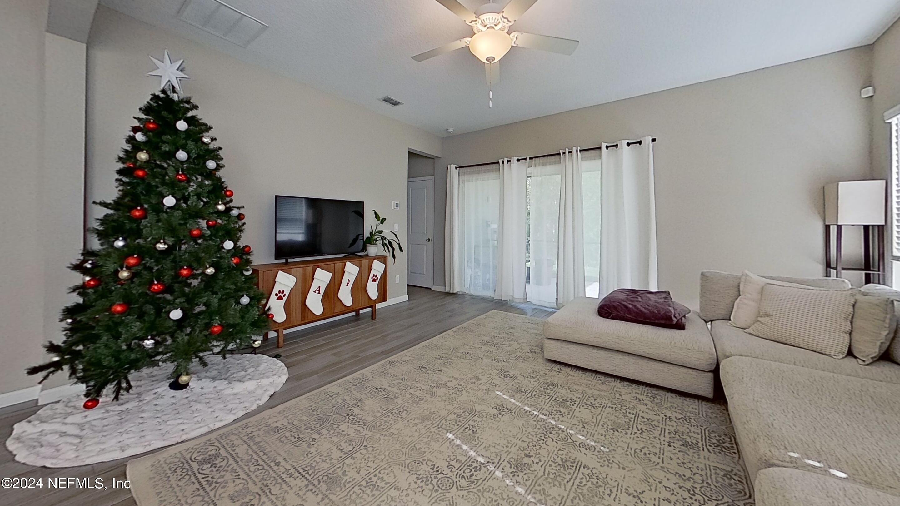 10887 Ventnor Avenue Jacksonville, FL 32218 - Photo 6 of 19 a living room with furniture potted plant and a fireplace