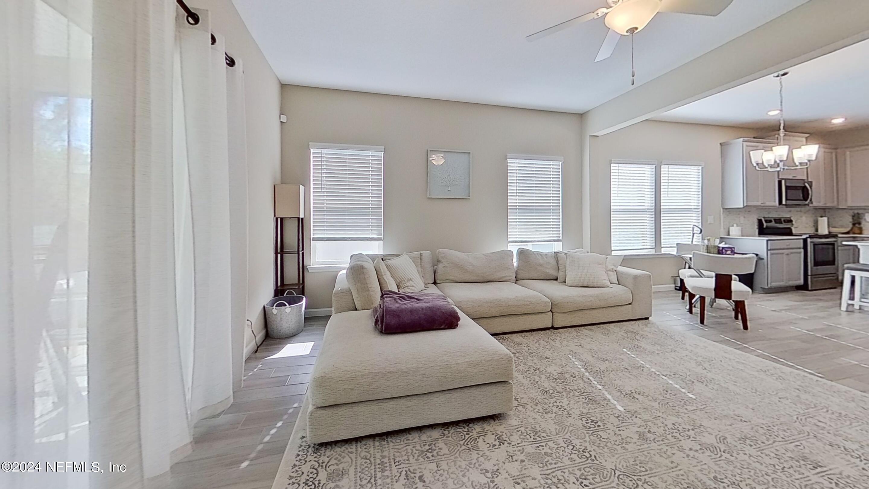 10887 Ventnor Avenue Jacksonville, FL 32218 - Photo 7 of 19 a living room with furniture and a large window
