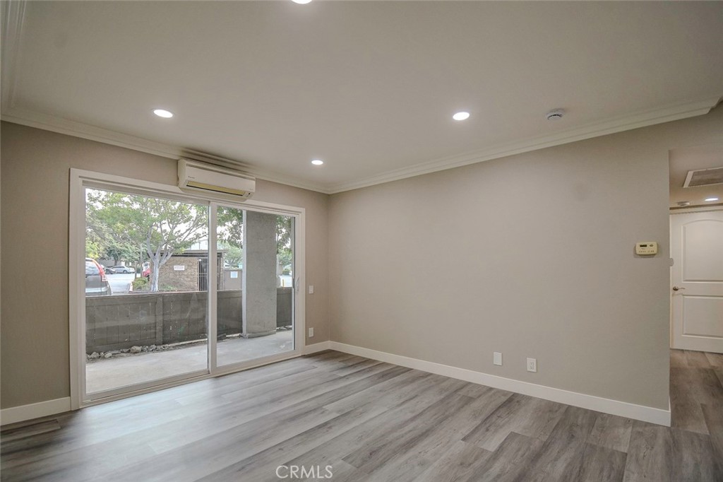 21941 Rimhurst Drive, Unit D Lake Forest, CA 92630 - Photo 12 of 44 a view of empty room with wooden floor and fan