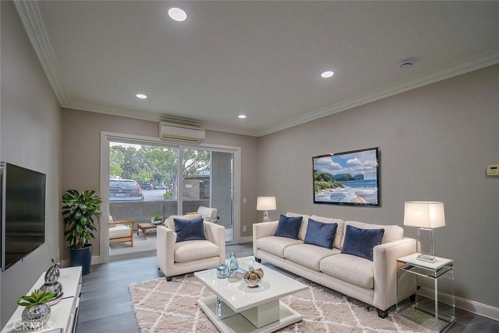 21941 Rimhurst Drive, Unit D Lake Forest, CA 92630 - Photo 13 of 44 a living room with furniture large window and a flat screen tv