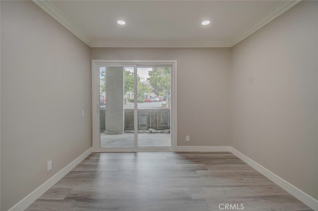 21941 Rimhurst Drive, Unit D Lake Forest, CA 92630 - Photo 20 of 44 an empty room with wooden floor and windows