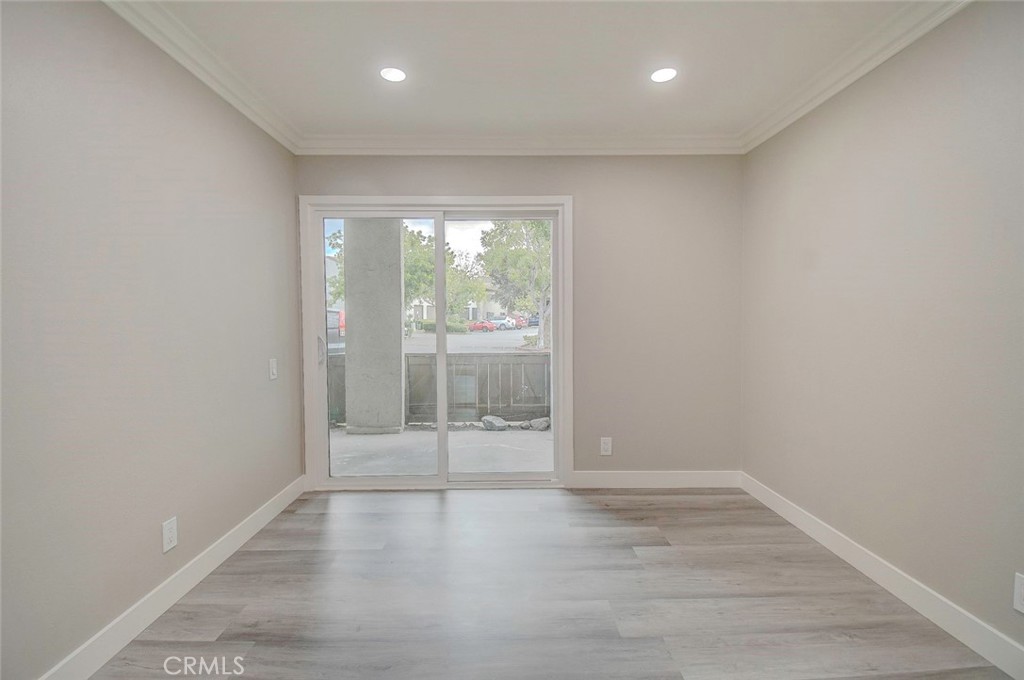 21941 Rimhurst Drive, Unit D Lake Forest, CA 92630 - Photo 23 of 44 an empty room with wooden floor and windows