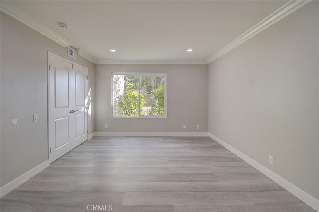 21941 Rimhurst Drive, Unit D Lake Forest, CA 92630 - Photo 26 of 44 wooden floor in an empty room with a window