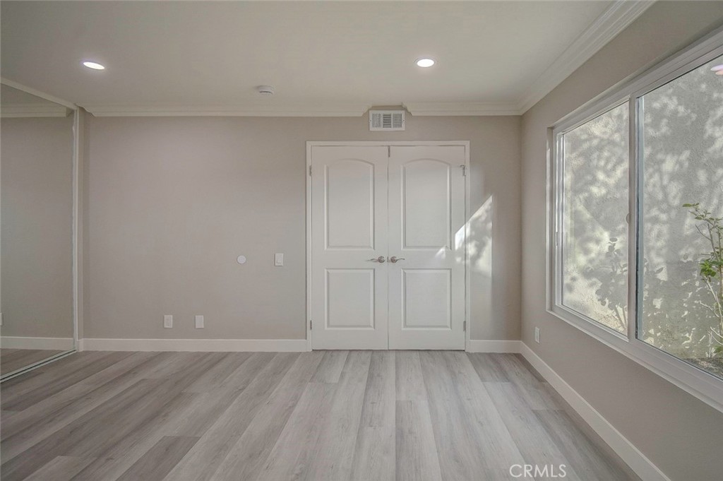 21941 Rimhurst Drive, Unit D Lake Forest, CA 92630 - Photo 31 of 44 wooden floor in an empty room with a window
