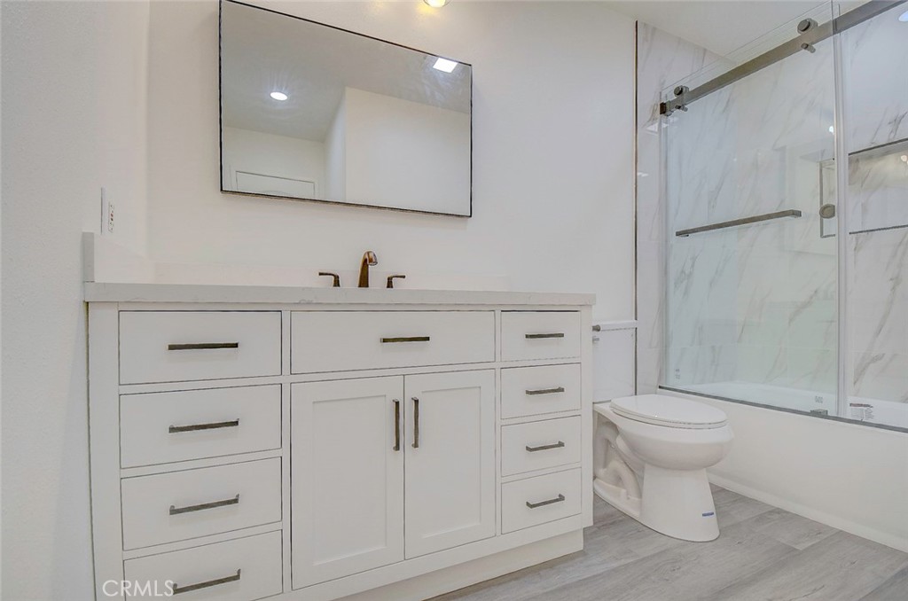 21941 Rimhurst Drive, Unit D Lake Forest, CA 92630 - Photo 33 of 44 a bathroom with a sink a toilet and shower