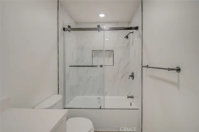 a bathroom with a sink toilet and mirror