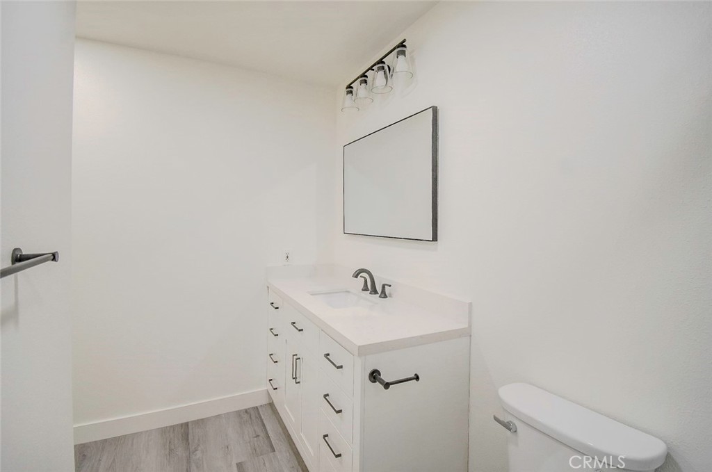 21941 Rimhurst Drive, Unit D Lake Forest, CA 92630 - Photo 35 of 44 a bathroom with a sink toilet and mirror