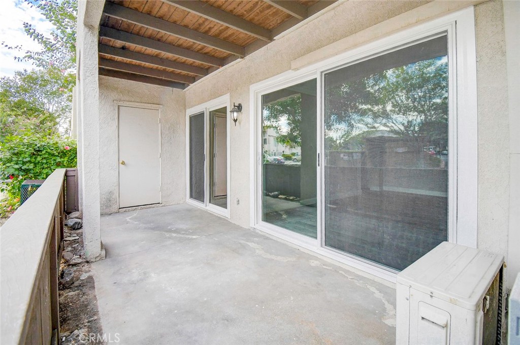 21941 Rimhurst Drive, Unit D Lake Forest, CA 92630 - Photo 38 of 44 a view of a glass door with a backyard