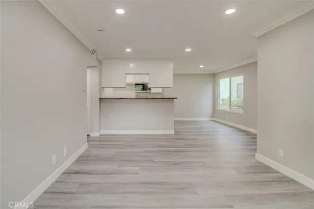 a view of kitchen with granite countertop cabinets and wooden floor