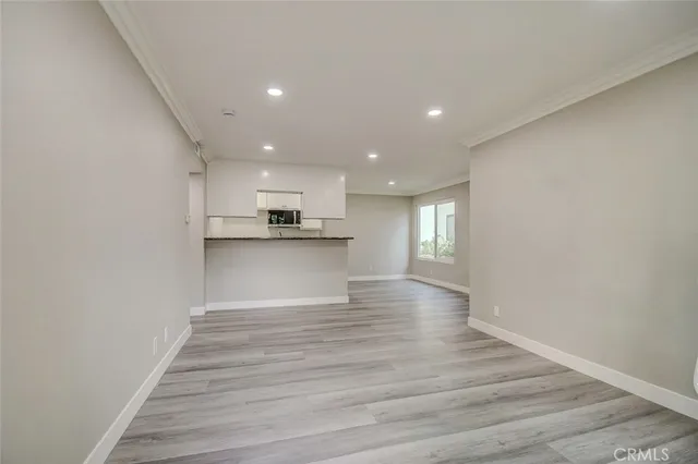 a kitchen with a refrigerator and a stove top oven