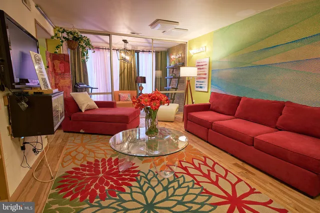 a living room with patio furniture and a flat screen tv