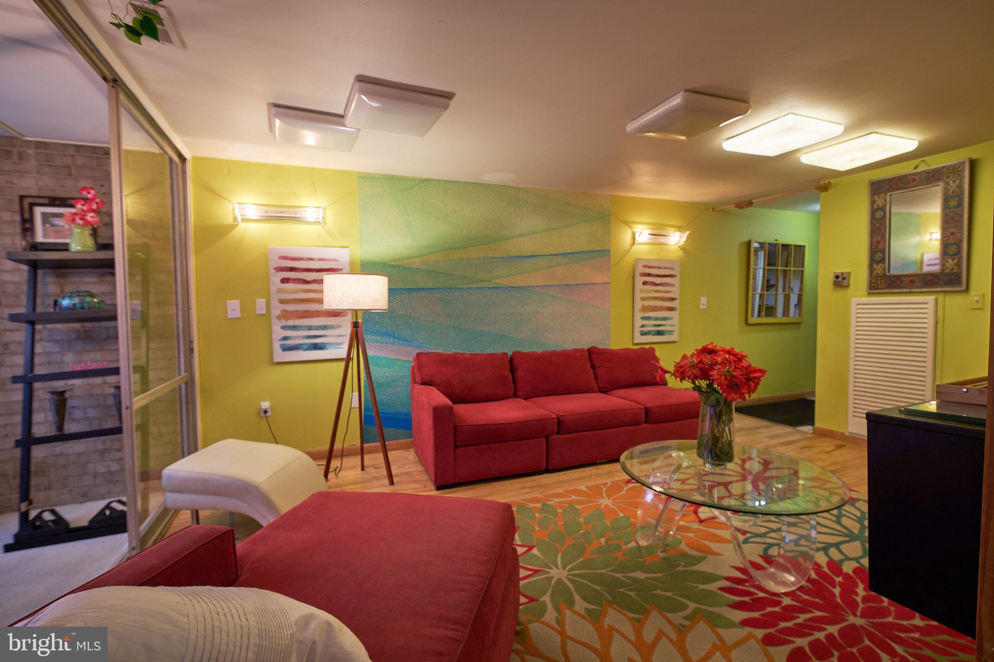 8677 Greenbelt Road, Unit 101 Greenbelt, MD 20770 - Photo 4 of 10 a living room with furniture and a flat screen tv