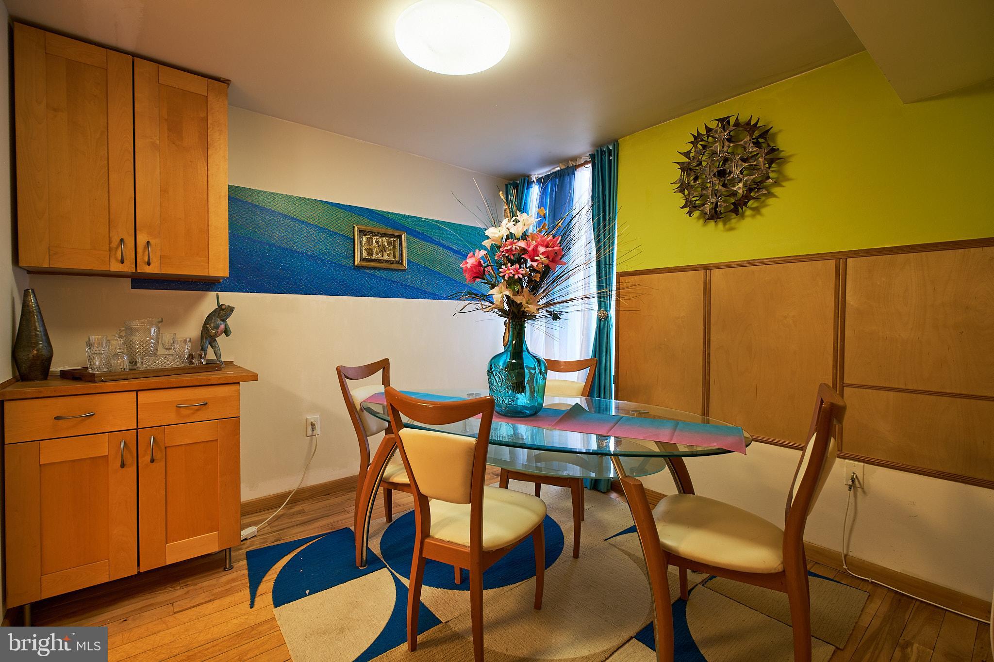 8677 Greenbelt Road, Unit 101 Greenbelt, MD 20770 - Photo 6 of 10 a view of a dining room with furniture and wooden floor