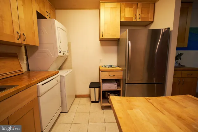 a kitchen with a refrigerator and cabinets
