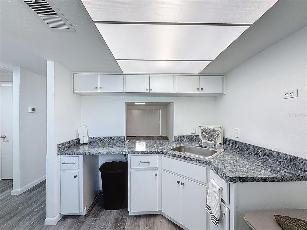 4224 Terrapin Place, Unit 4224 New Port Richey, FL 34652 - Photo 11 of 58 a kitchen with granite countertop cabinets stainless steel appliances and a counter space