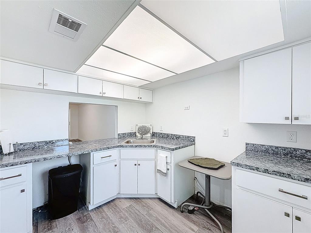 4224 Terrapin Place, Unit 4224 New Port Richey, FL 34652 - Photo 13 of 58 a kitchen with a sink cabinets and wooden floor