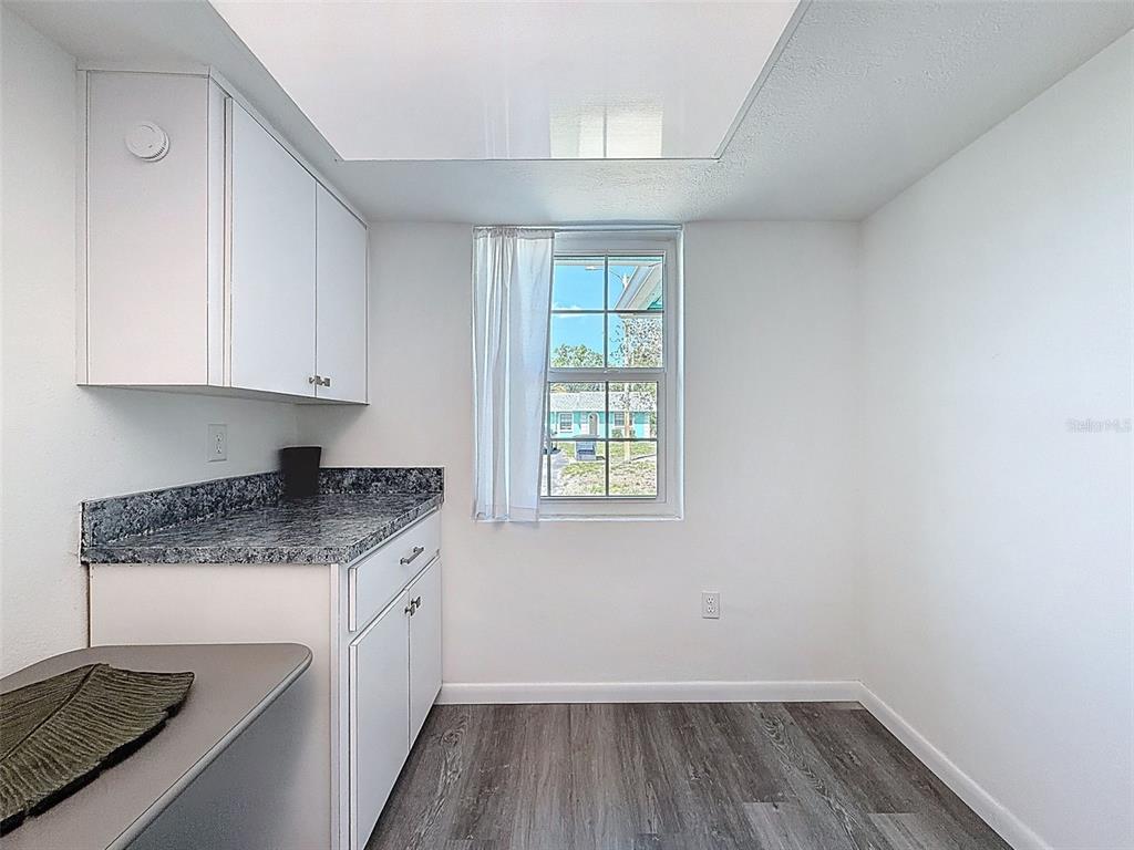 4224 Terrapin Place, Unit 4224 New Port Richey, FL 34652 - Photo 14 of 58 a kitchen with a sink window and cabinets