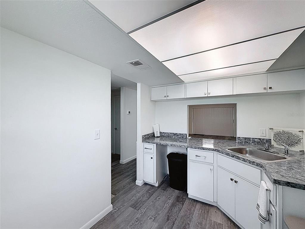 4224 Terrapin Place, Unit 4224 New Port Richey, FL 34652 - Photo 17 of 58 a kitchen with granite countertop a stove top oven sink and cabinets