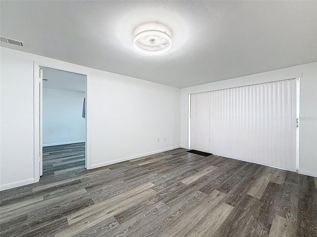 4224 Terrapin Place, Unit 4224 New Port Richey, FL 34652 - Photo 20 of 58 a view of an empty room with wooden floor and a window
