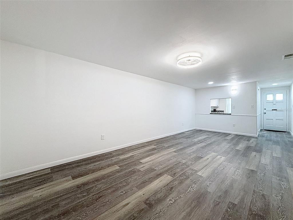 4224 Terrapin Place, Unit 4224 New Port Richey, FL 34652 - Photo 22 of 58 an empty room with wooden floor and windows