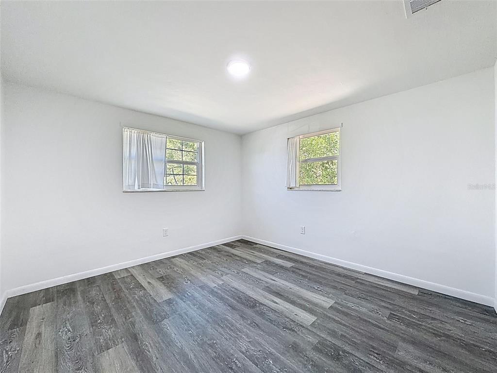 4224 Terrapin Place, Unit 4224 New Port Richey, FL 34652 - Photo 23 of 58 an empty room with wooden floor and windows