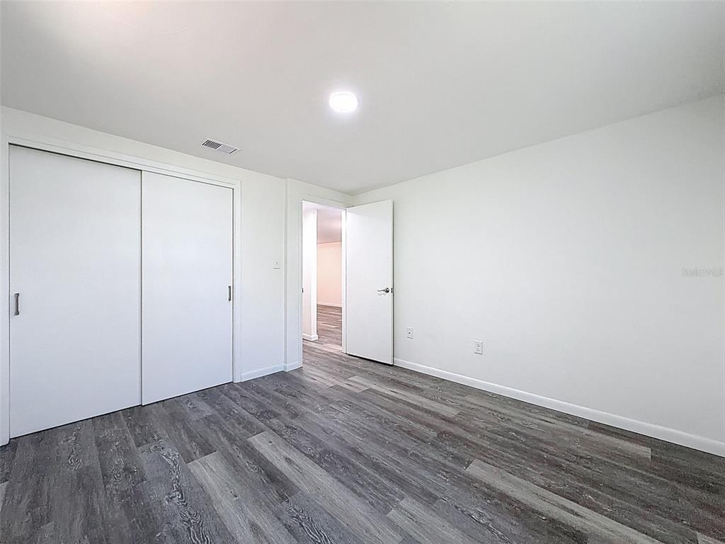 4224 Terrapin Place, Unit 4224 New Port Richey, FL 34652 - Photo 25 of 58 a view of an empty room with wooden floor