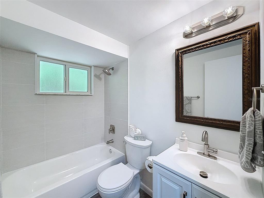4224 Terrapin Place, Unit 4224 New Port Richey, FL 34652 - Photo 28 of 58 a bathroom with a toilet sink vanity tub and mirror
