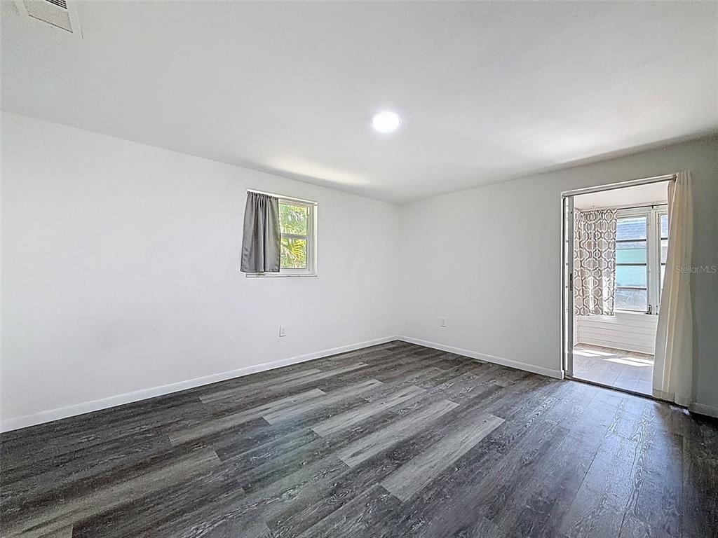 4224 Terrapin Place, Unit 4224 New Port Richey, FL 34652 - Photo 29 of 58 a view of an empty room with wooden floor and a window
