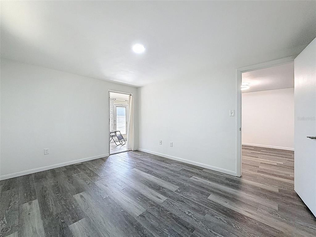 4224 Terrapin Place, Unit 4224 New Port Richey, FL 34652 - Photo 30 of 58 a view of an empty room with wooden floor and a window