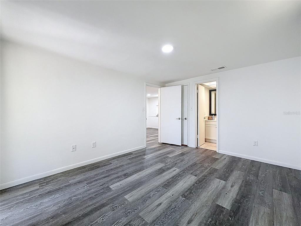 4224 Terrapin Place, Unit 4224 New Port Richey, FL 34652 - Photo 31 of 58 a view of an empty room with wooden floor and window