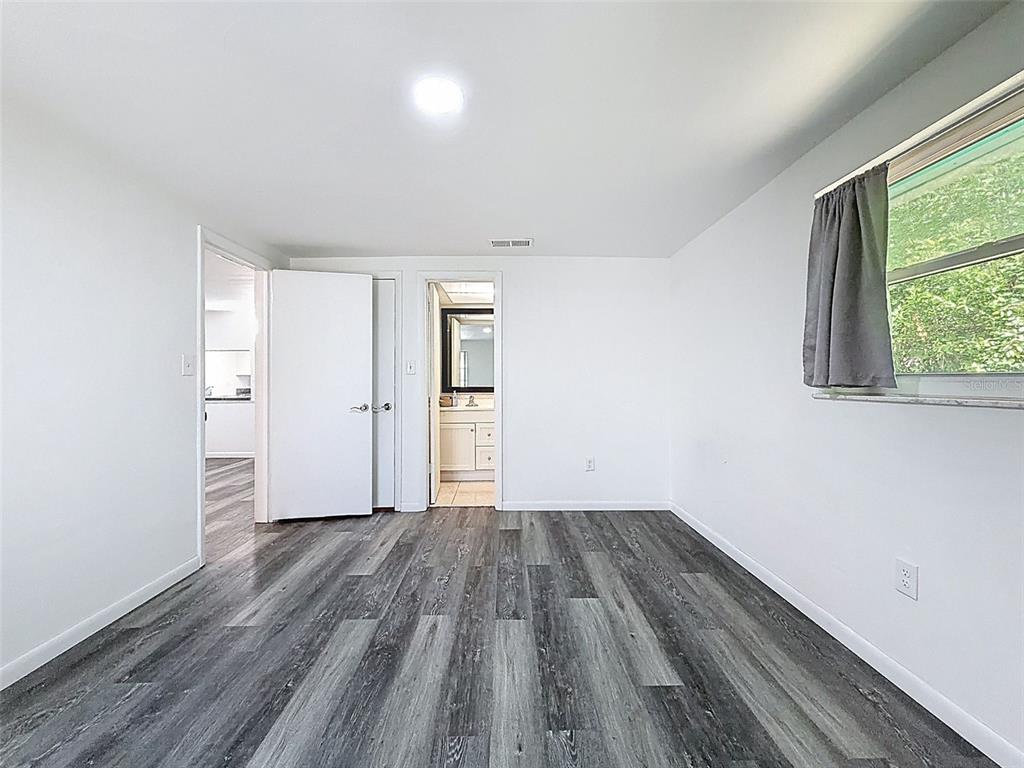 4224 Terrapin Place, Unit 4224 New Port Richey, FL 34652 - Photo 32 of 58 wooden floor in an empty room with a window