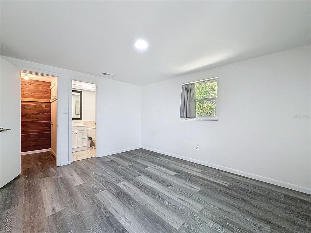 4224 Terrapin Place, Unit 4224 New Port Richey, FL 34652 - Photo 33 of 58 wooden floor in an empty room with a window