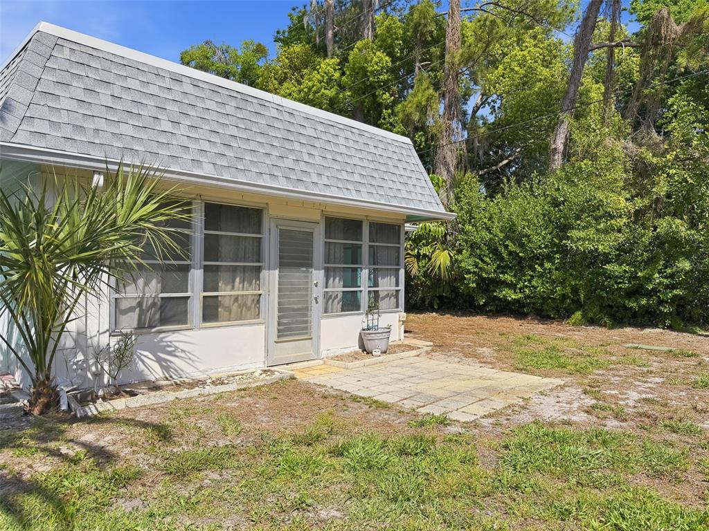 4224 Terrapin Place, Unit 4224 New Port Richey, FL 34652 - Photo 47 of 58 a view of a house with a yard and floor to ceiling window