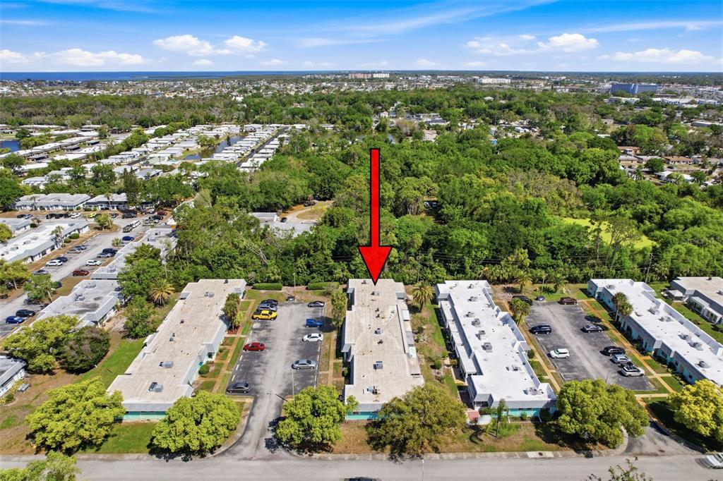 4224 Terrapin Place, Unit 4224 New Port Richey, FL 34652 - Photo 57 of 58 an aerial view of a city with lots of residential buildings ocean and mountain view in back