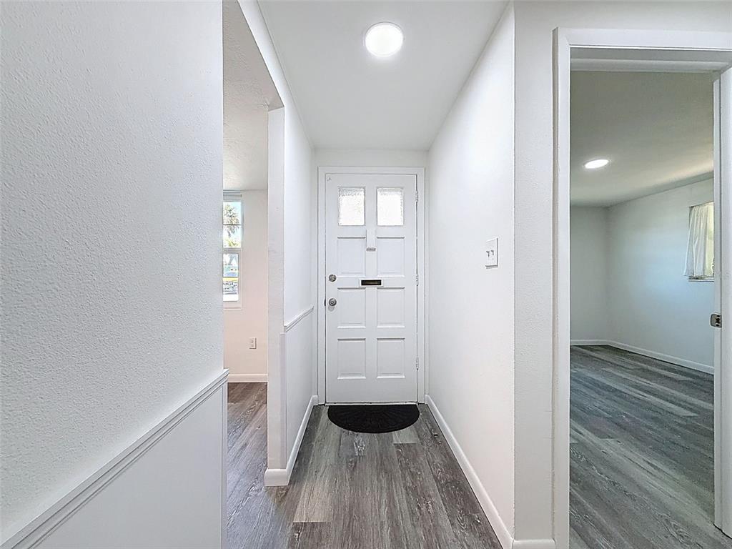4224 Terrapin Place, Unit 4224 New Port Richey, FL 34652 - Photo 7 of 58 a view of a hallway with wooden floor and staircase