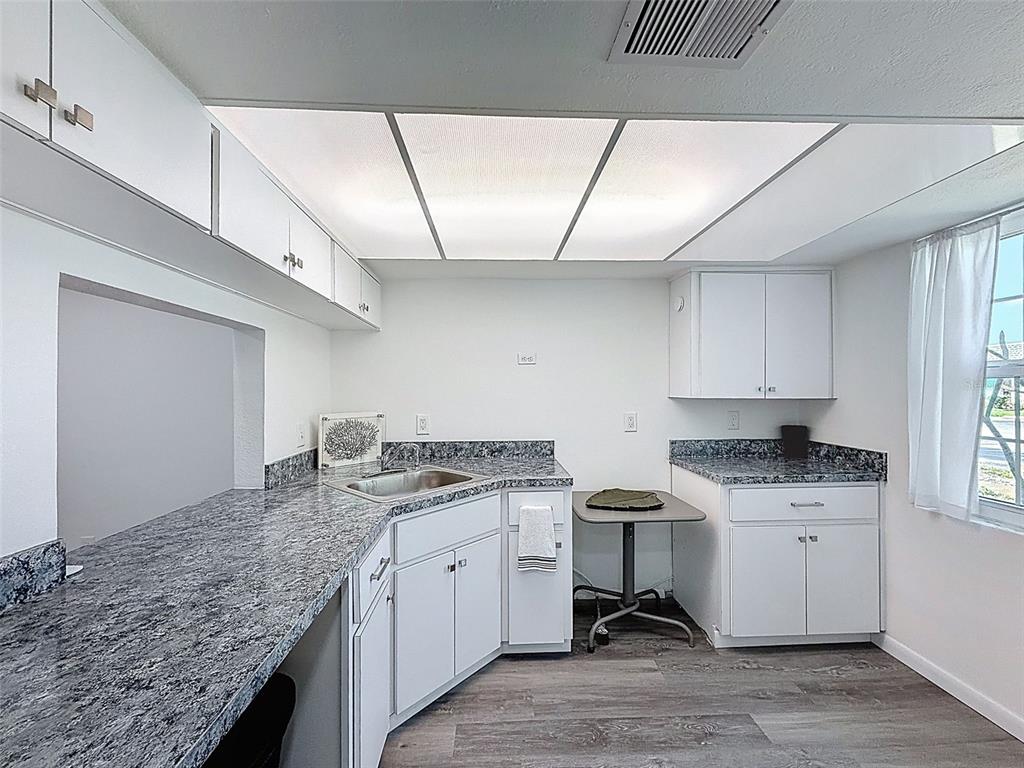 4224 Terrapin Place, Unit 4224 New Port Richey, FL 34652 - Photo 9 of 58 a kitchen with a stove a sink and cabinets