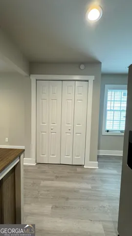 a view of deck with wooden fence and trees