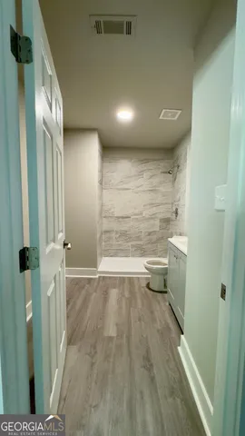 a bathroom with a toilet and a bathtub