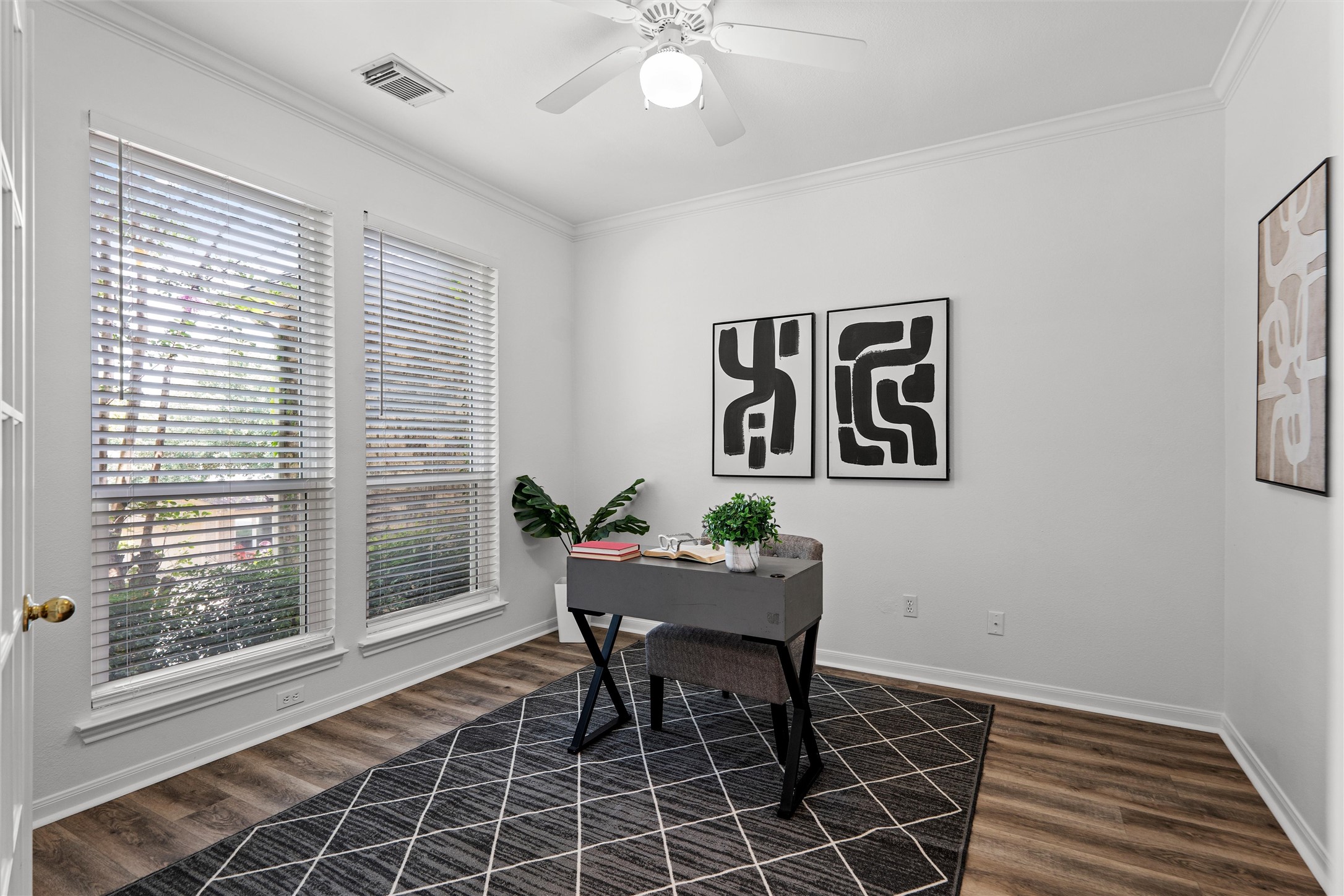7000 Colberg Court Austin, TX 78749 - Photo 7 of 40 A well-lit home office features rich wood flooring, crown molding, and a refreshing ceiling fan for productive days.