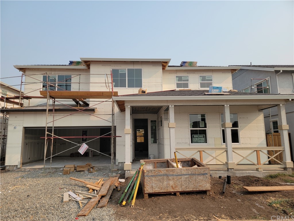 a view of a house with backyard and sitting area