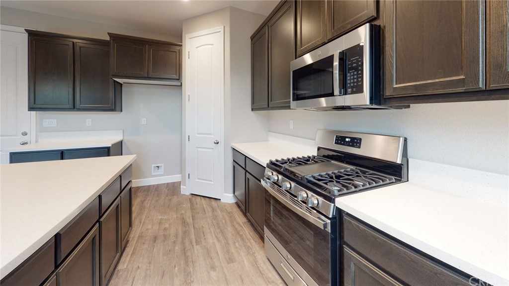 63 Bentwater Loop Chico, CA 95973 - Photo 16 of 20 a kitchen with stainless steel appliances a sink dishwasher a stove top oven a refrigerator with grey cabinets