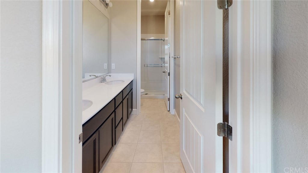 63 Bentwater Loop Chico, CA 95973 - Photo 7 of 20 a bathroom with a double vanity sink and mirror