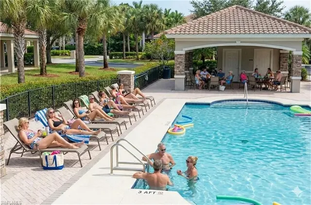a view of a white house with a yard patio and fire pit
