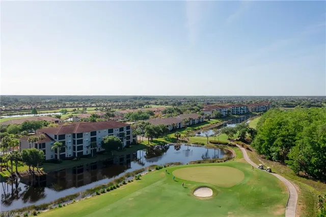 an aerial view of residential houses with outdoor space and swimming pool