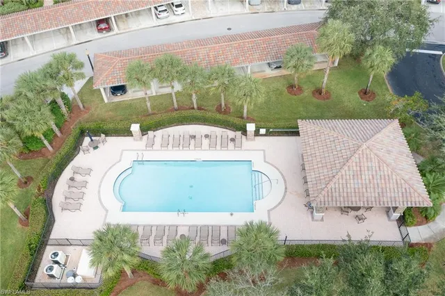 an aerial view of a house with a yard and lake view